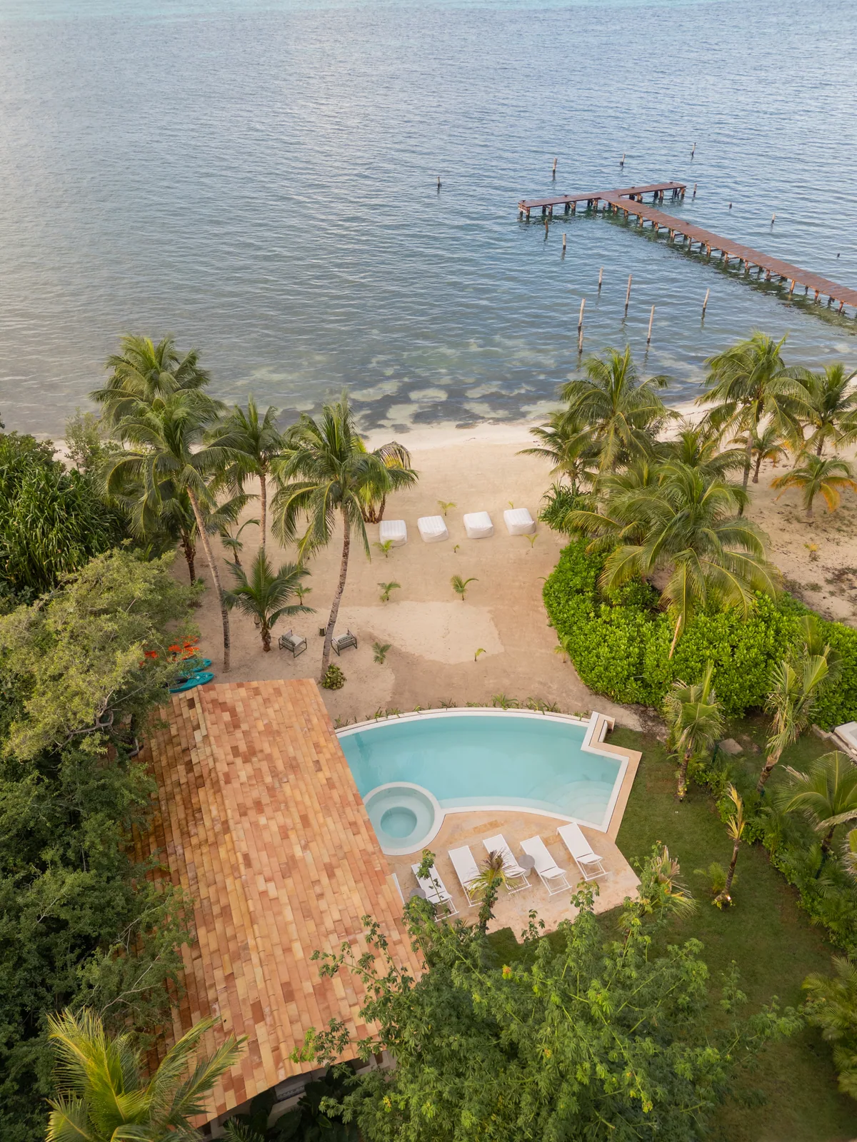 Aerial view of the dock, the beach and a residence pool at La Colección Residences