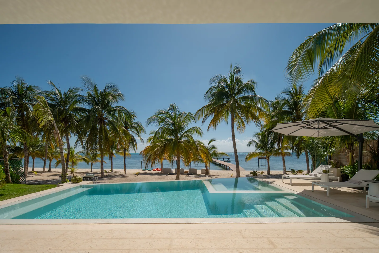 The heated pool at Casa Azul with the palms and the sea beyond