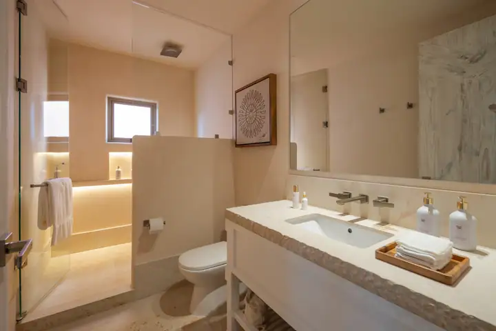 A stone vanity and walk-in shower in a Casa Azul bathroom