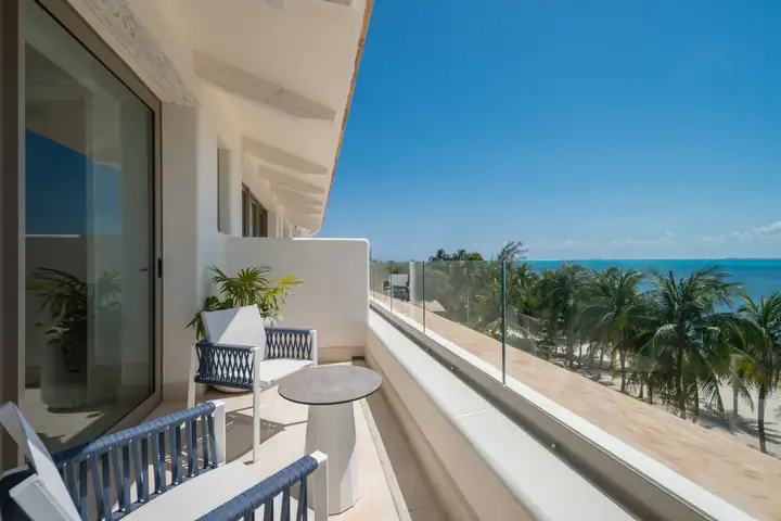 The balcony of Double Room 2 at Casa Azul, palms and the Caribbean below