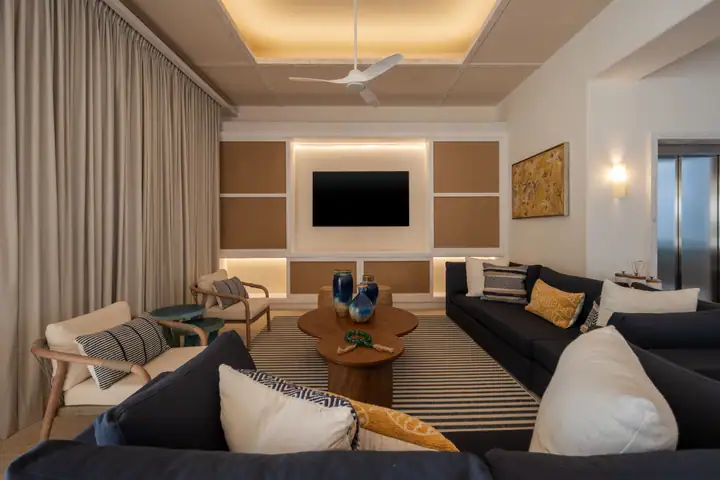The family room at Casa Azul with navy sofas and a large screen