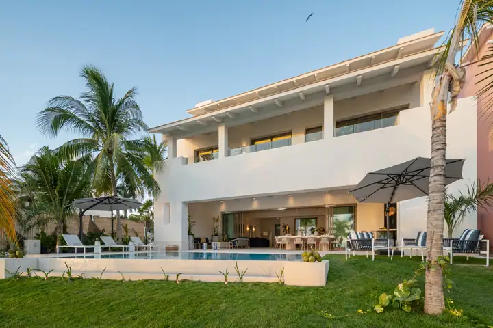 Casa Azul across its lawn and pool, palms framing the white house
