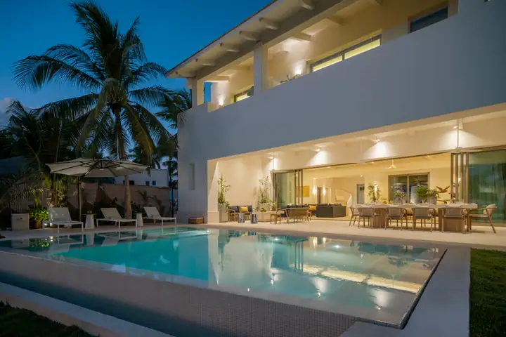Casa Azul on Isla Mujeres at dusk: the lit house behind its rectangular pool