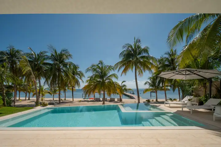 The heated pool at Casa Azul with the palms and the sea beyond