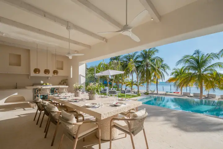 The terrace dining area at Casa Azul open to the pool and the palms