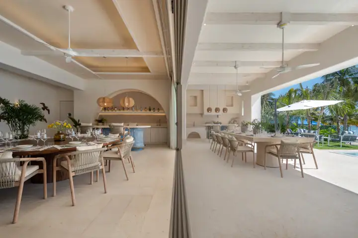 The covered terrace at Casa Azul with the outdoor kitchen and two dining tables