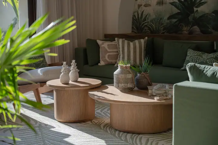 Woven vessels and round wooden coffee tables in the Casa Ceiba lounge