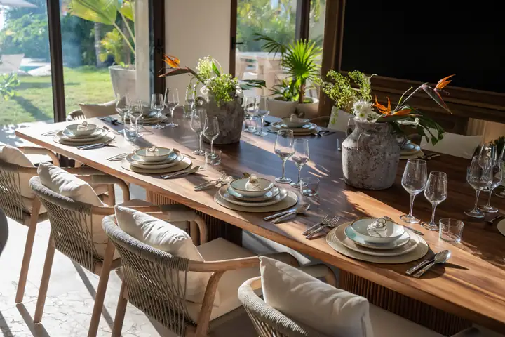 The long dining table at Casa Ceiba set for dinner, glasses and linen ready