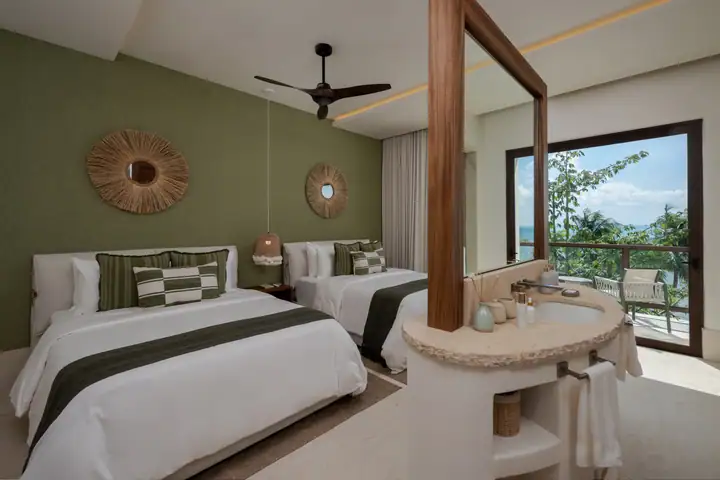 Double Room 2 at Casa Ceiba with two queen beds and green linen
