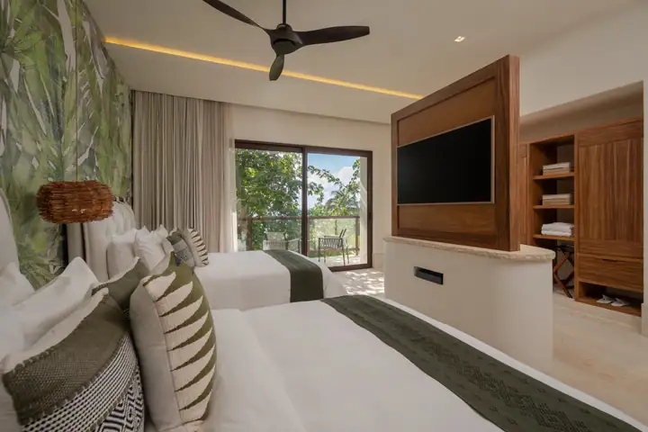 Double Room 5 at Casa Ceiba with two queen beds and a garden view