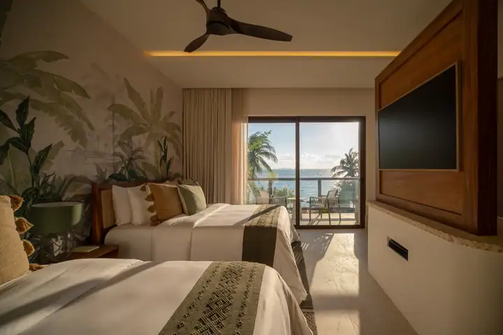 Double Room 6 at Casa Ceiba with two queen beds and a sea view