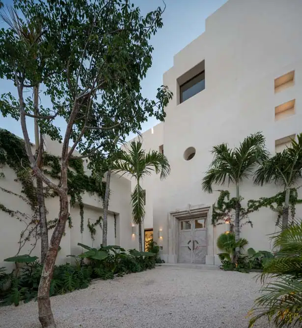 The white entry courtyard and front door of Casa Ceiba