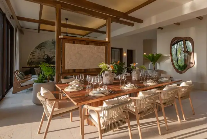 The indoor dining table at Casa Ceiba with the bar beyond