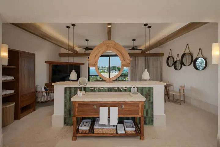 The double vanity and round mirror in the Casa Ceiba master bathroom