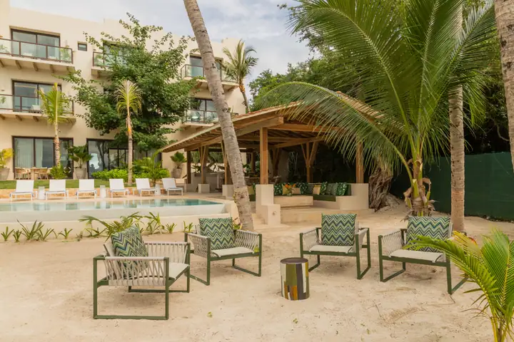The palapa and garden lounge chairs at Casa Ceiba among the palms