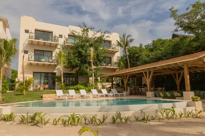 Casa Ceiba on Isla Mujeres: the curved pool, the palapa lounge and the three-storey house