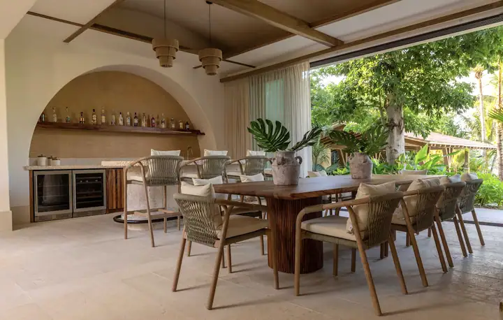 The covered terrace dining area and bar at Casa Ceiba