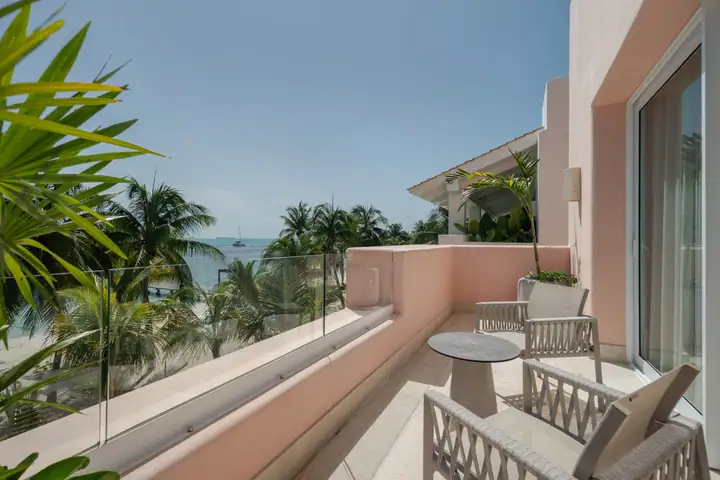 A bedroom balcony at Casa Coral over the palms and the sea