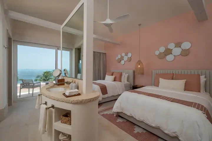 Double Room 3 at Casa Coral with two queen beds and a sea view