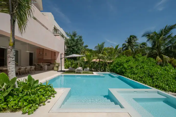 The Casa Coral pool from the covered terrace, gardens around it
