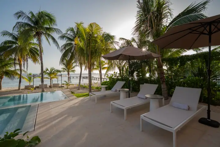 Loungers on the pool deck at Casa Coral, a few steps from the sand