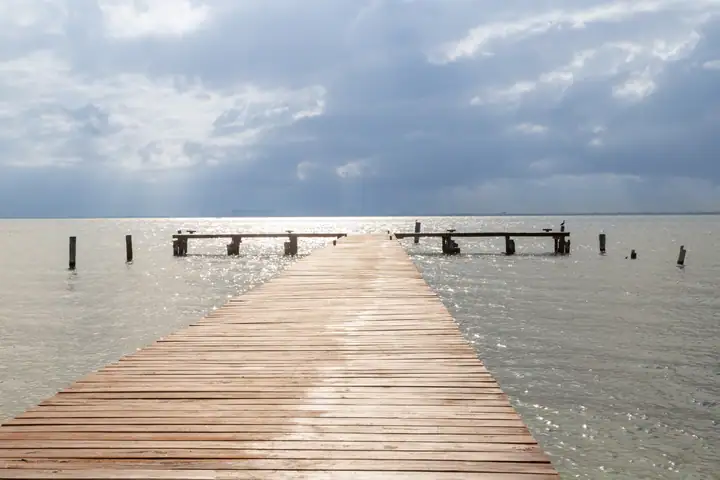 The private dock stretching into the calm Bahía de Mujeres at first light