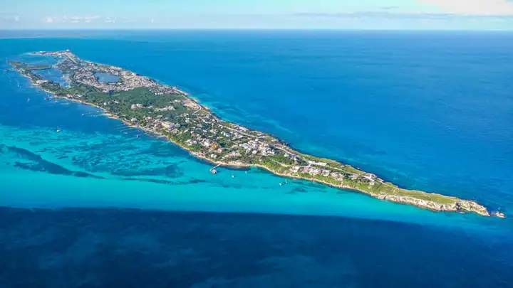 Isla Mujeres from the air, a narrow island in the turquoise Caribbean off Cancún