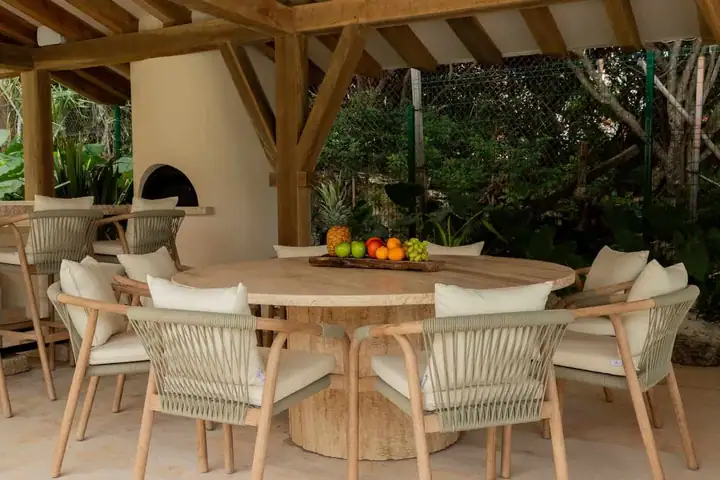 The round terrace dining table beside the wood-fired oven at Casa Ceiba